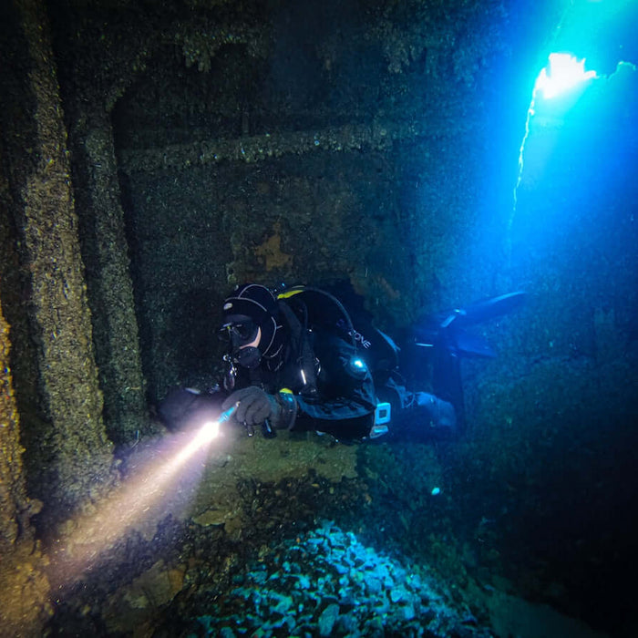 Adventure A Guide to the XTAR D26 2500 Diving Flashlight showcasing a diver exploring underwater ruins.