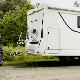 Image showcasing the Thule 3rd Rail Bike Rack Range with bikes beside an RV in nature.