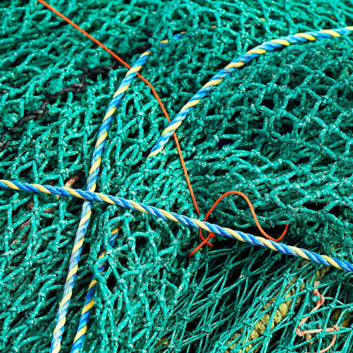 2mm x 100 pcs Alli Crimps Size E woven into colorful fishing nets.
