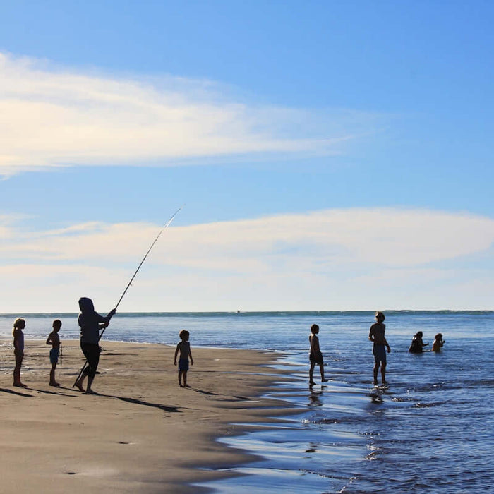 Kids fishing on the beach, showcasing activities related to NZ Made Flounder Beach Drag Nets.