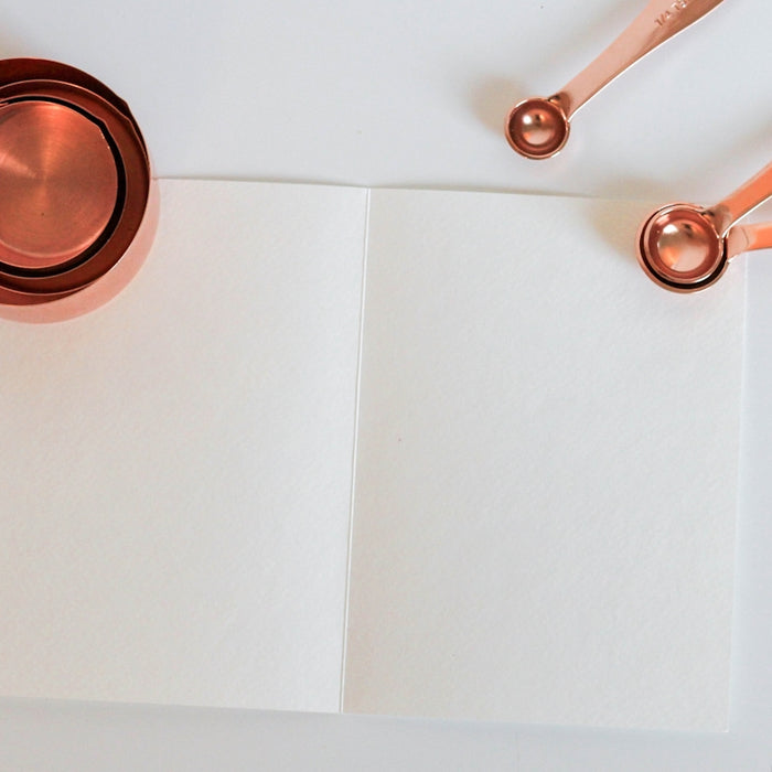 measuring cup on white paper