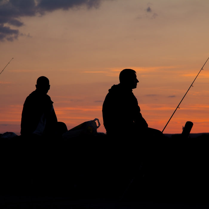 silhoette of man fishing
