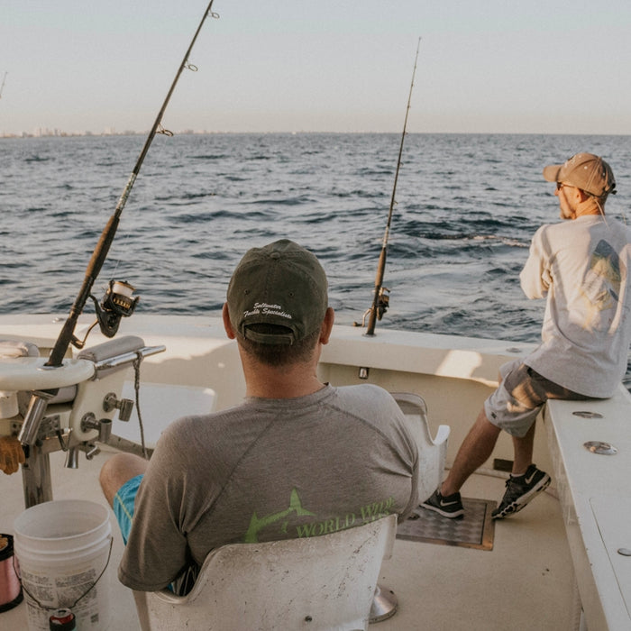 two men doing fishing during daytime