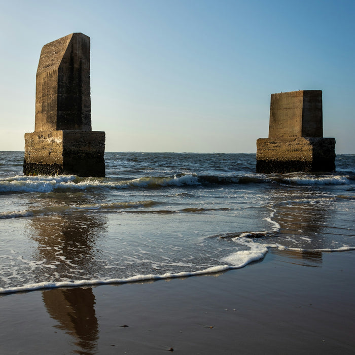 brown concrete building on sea shore during daytime