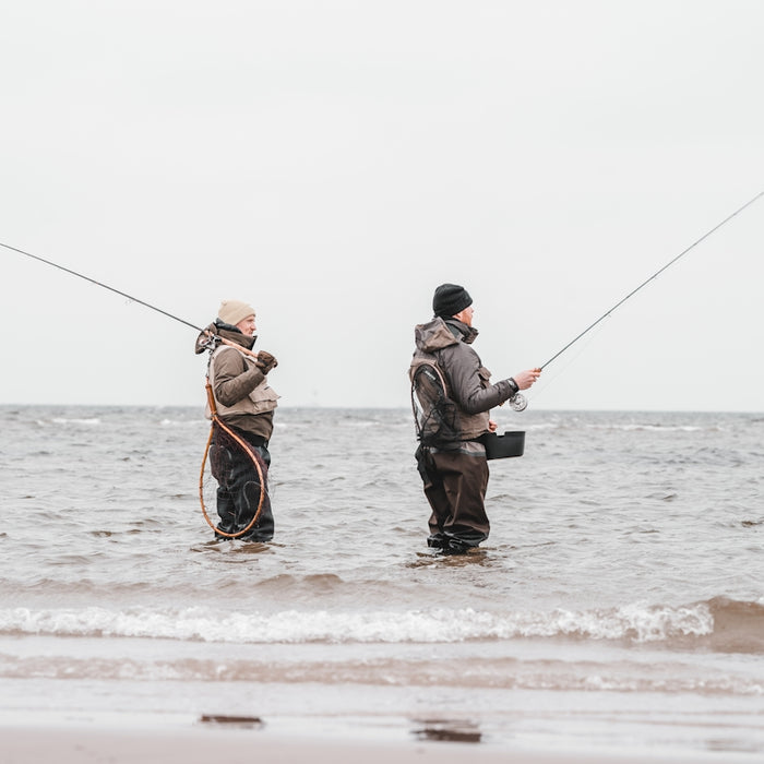 2 men fishing on sea during daytime