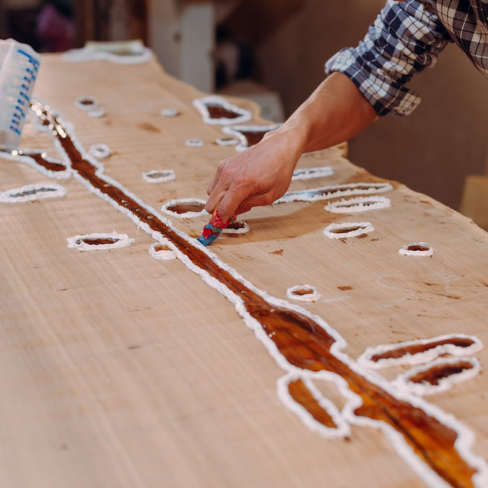 a person that is cutting a piece of wood