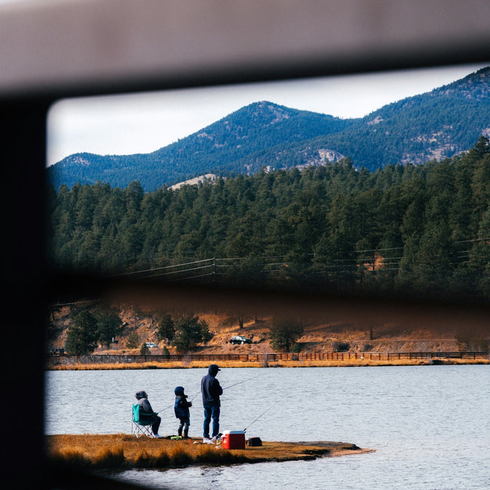 a group of people standing on top of a boat in a lake