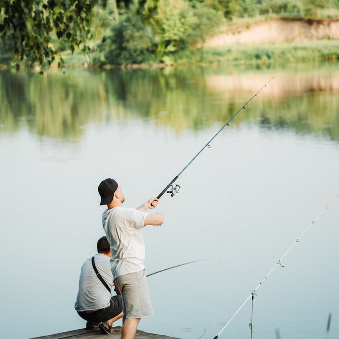 a man and a boy fishing on a dock