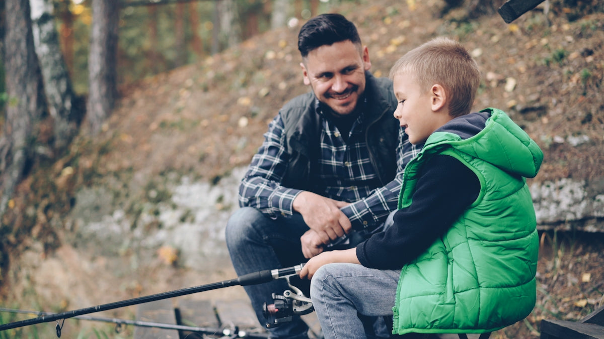 Father and son are enjoying a fishing trip.