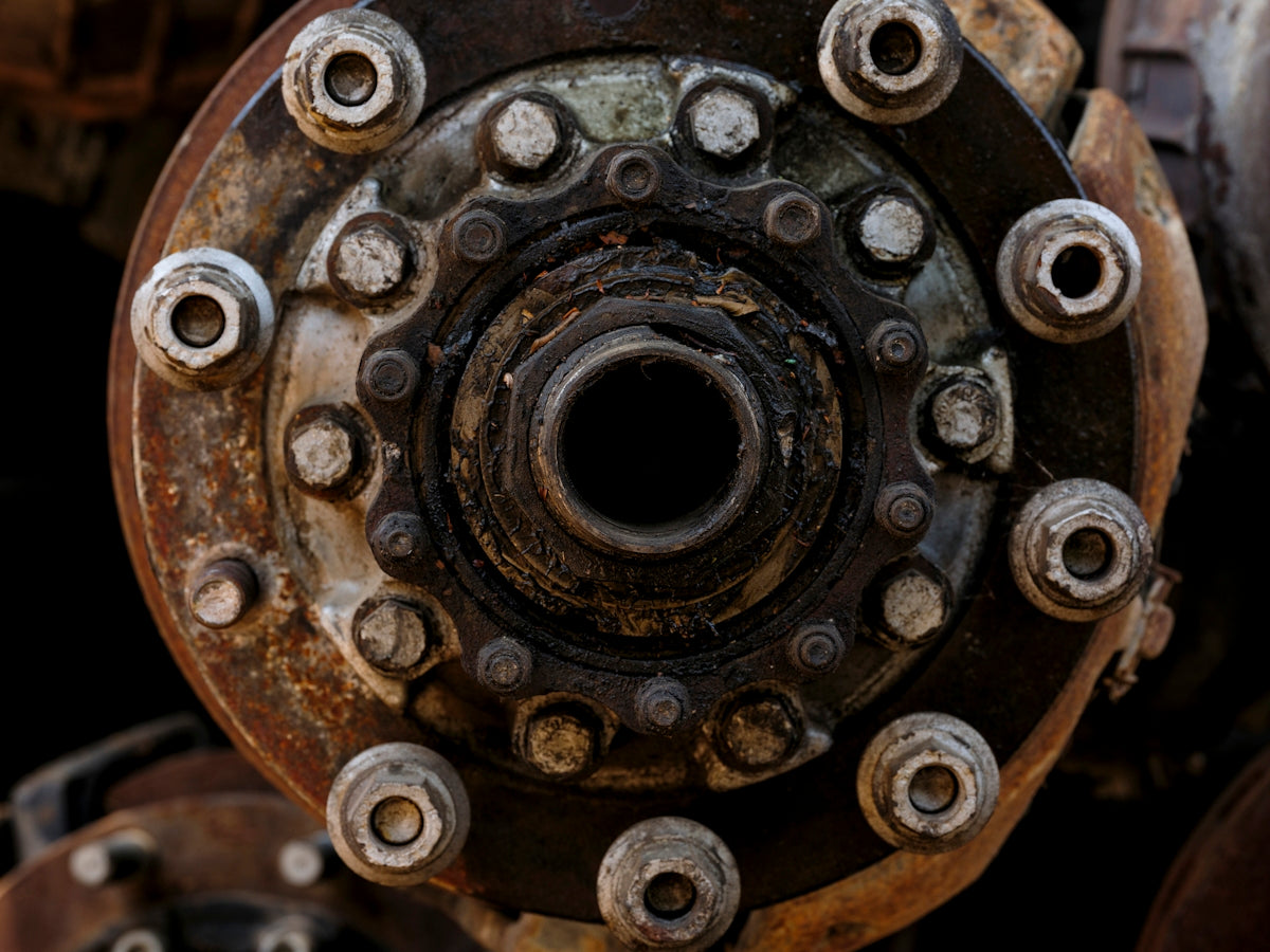 Close-up of a rusty, weathered wheel hub assembly